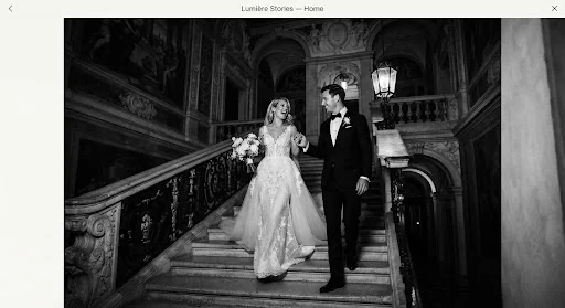 Atmospheric dusk black and white architectural portrait of couple on grand stone stairs of a Venetian palazzo, Aman Venice, high contrast chiaroscuro flash, couture wedding gown, fine grain art photograph