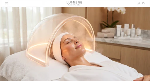 Hyperbaric oxygen dome emitting a soft warm luminescence over a serene face in a luxury spa sanctuary, fine mist droplets catch amber light highlights, editorial beauty shot